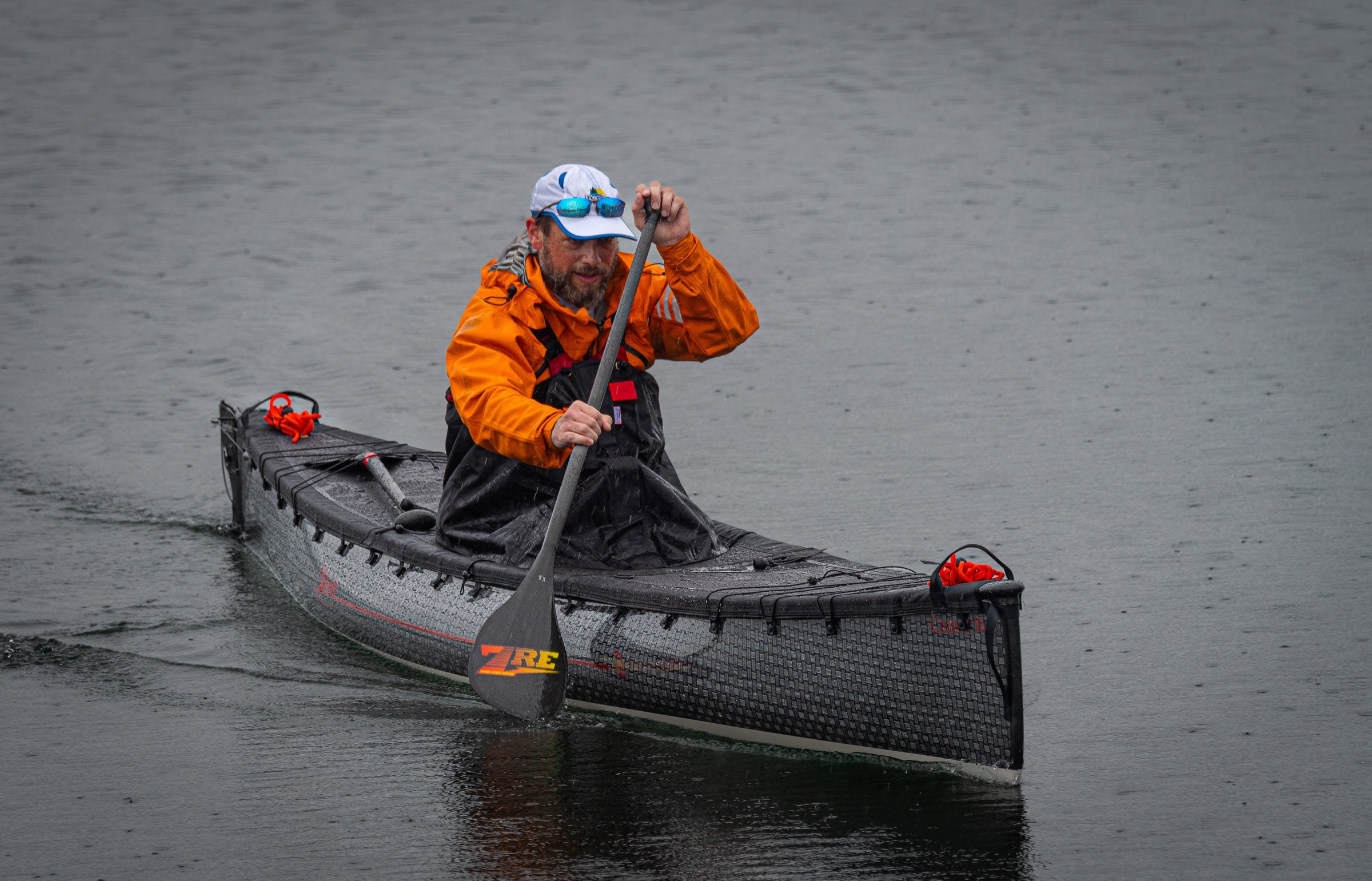 Solo expedition spray deck installed on a cruiser canoe on open water